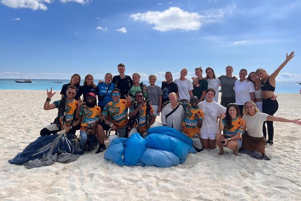 a group of people posing for a picture on the beach