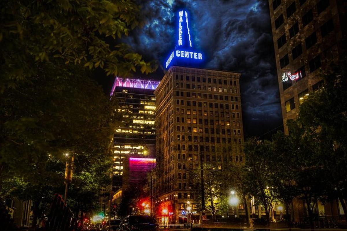 a building with a neon sign on top of it at night