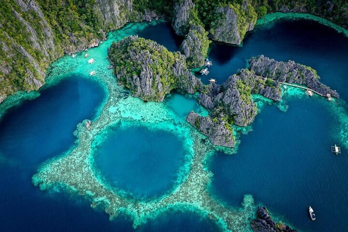 an aerial view of two turquoise water islands