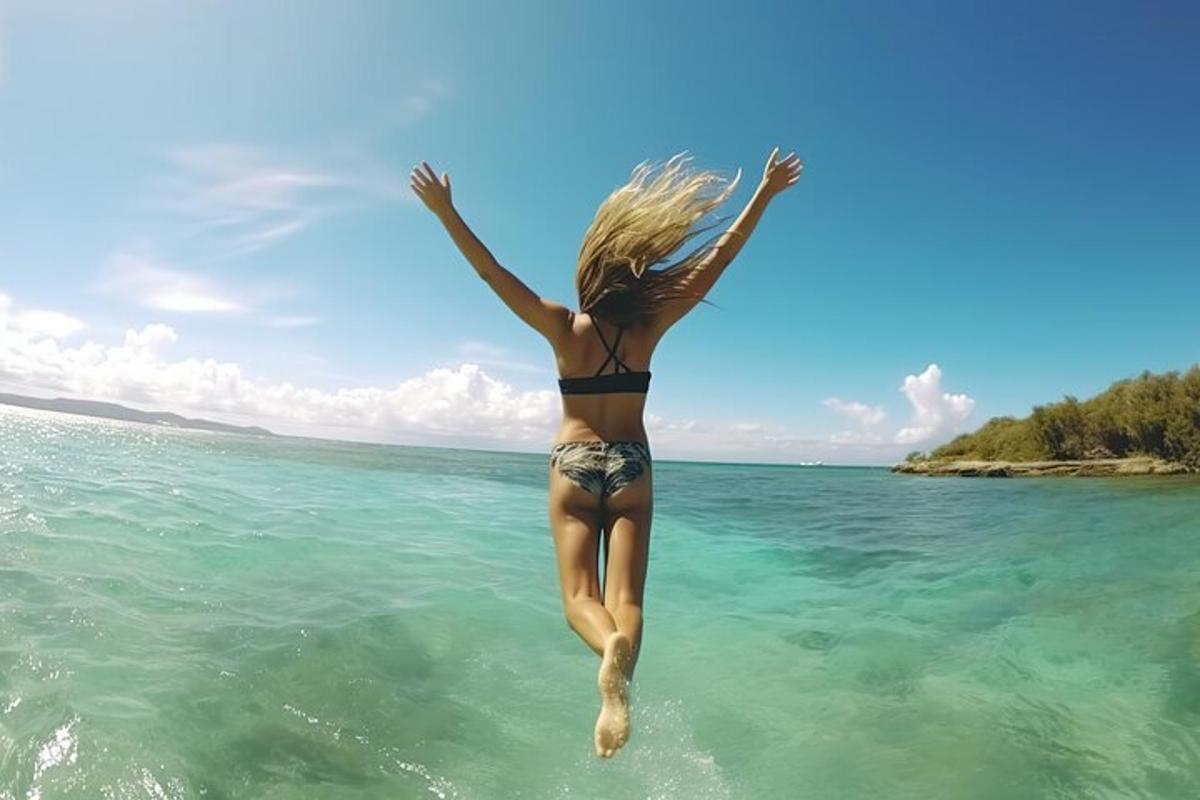 a woman jumping into the water in the ocean