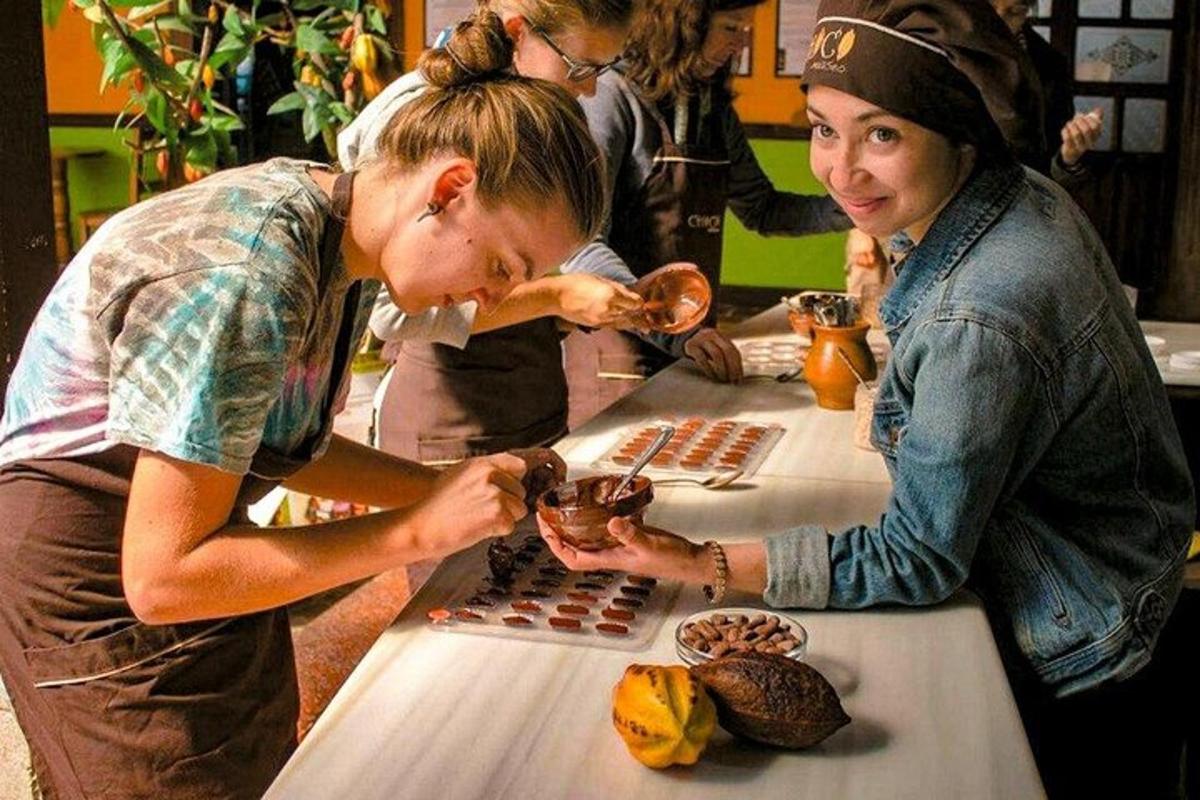 two women are standing at a table eating food