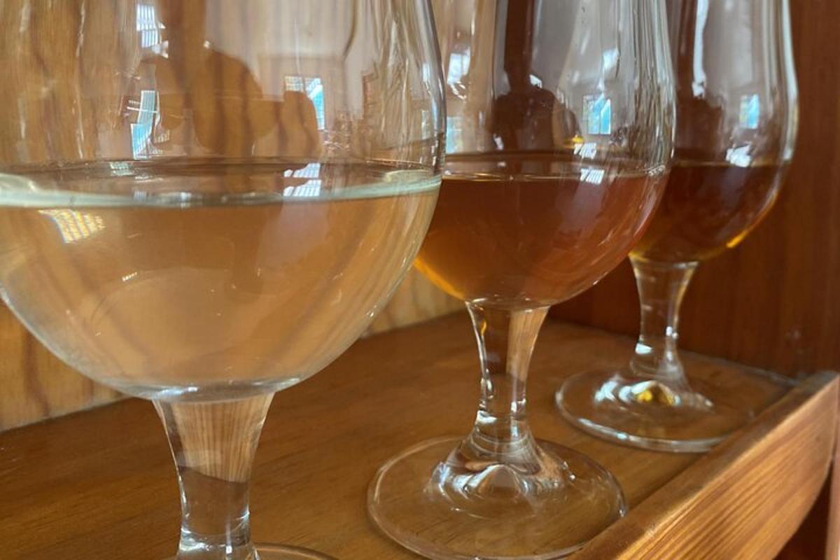 three glasses of wine sitting on a wooden table