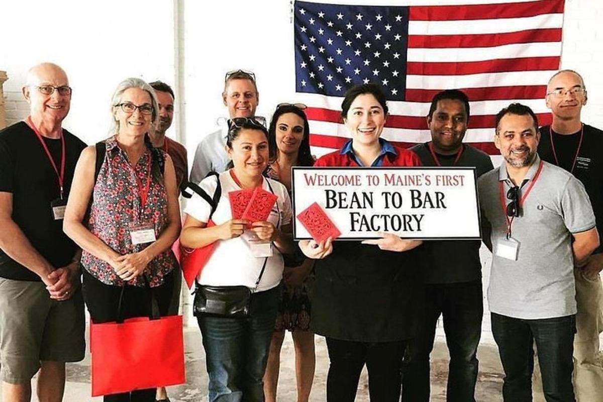 a group of people holding a sign with an american flag