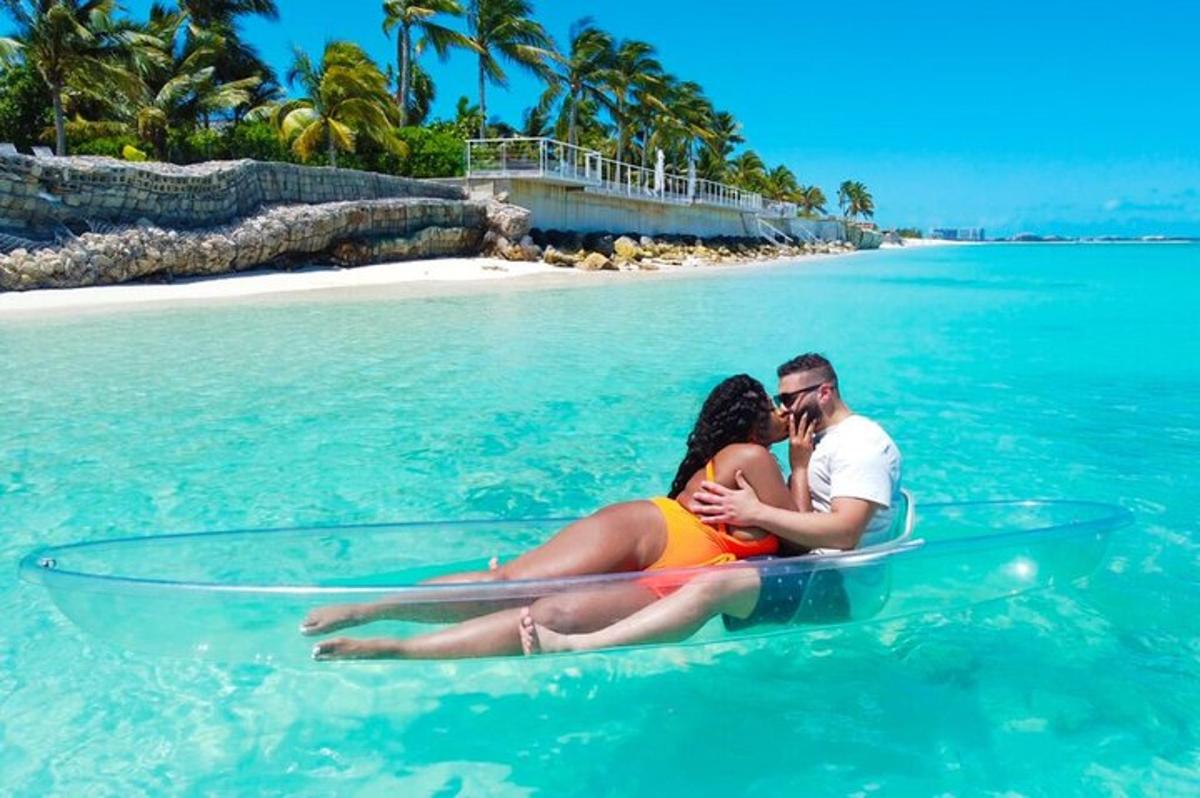 a man and woman sitting on a surfboard in the water