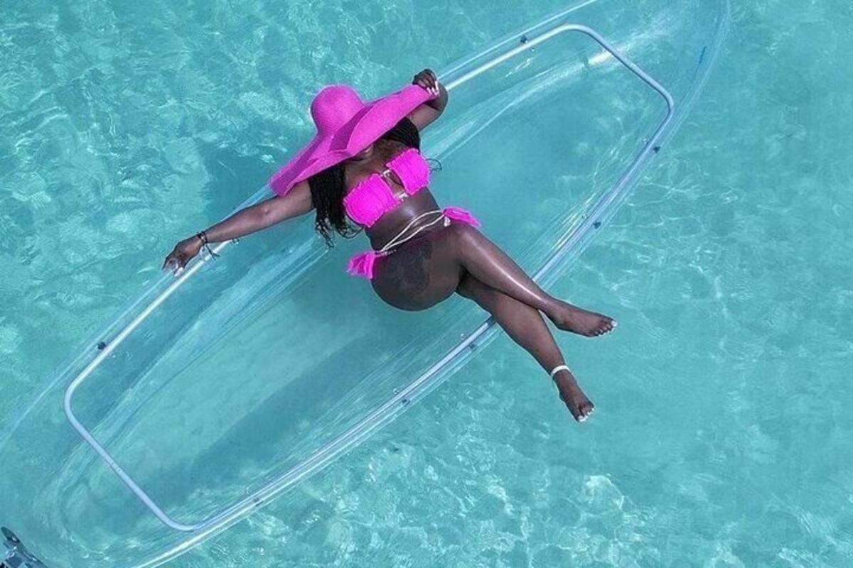 a woman in a pink hat is in the water