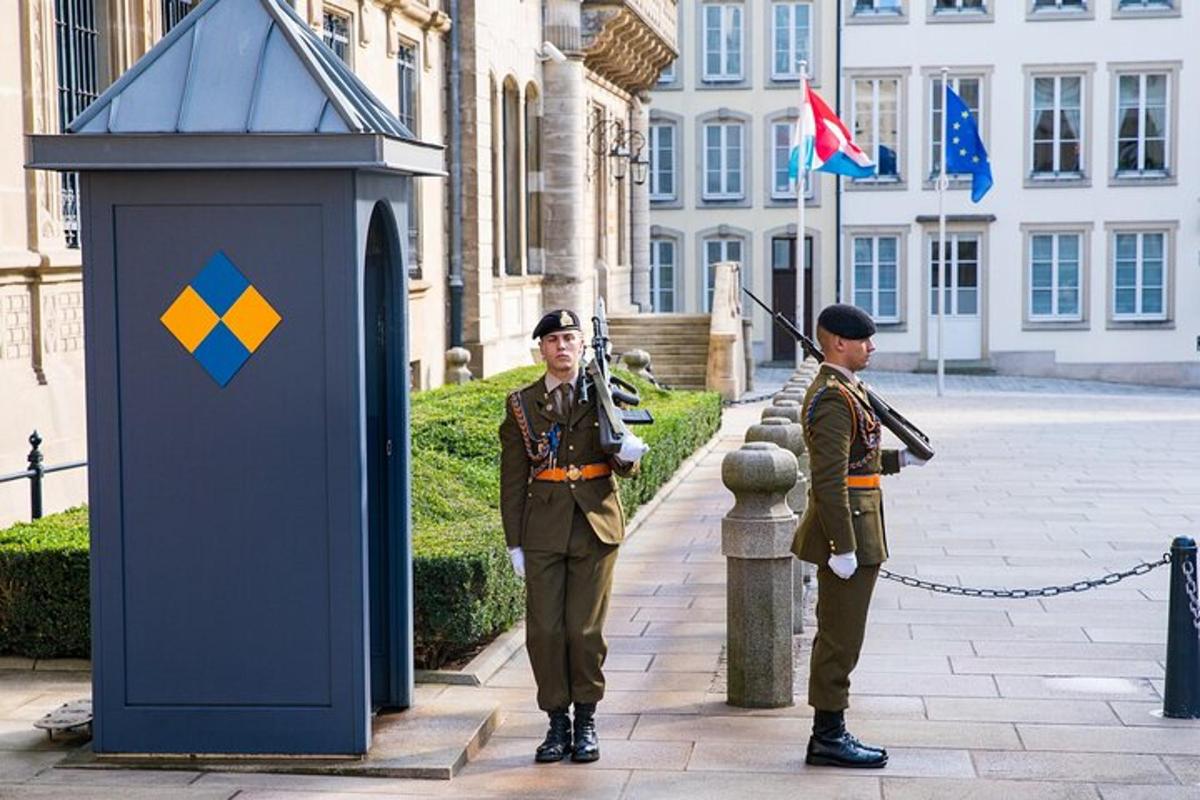 two men in uniform standing in front of a building