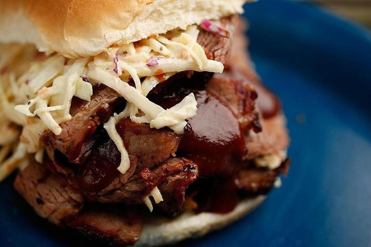 a sandwich with meat and cheese on a blue plate
