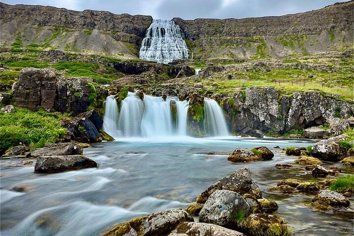 a waterfall in the middle of a river with rocks