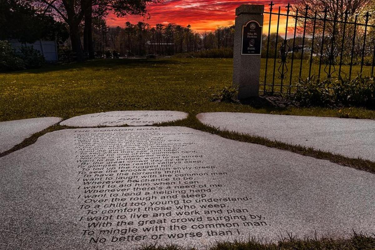 a stone grave in a park with a sunset in the background