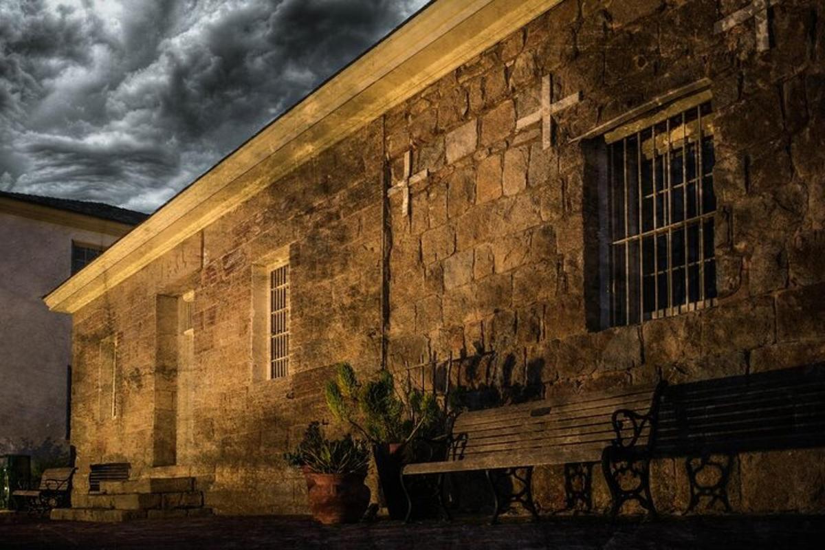 a brick building with a bench in front of it