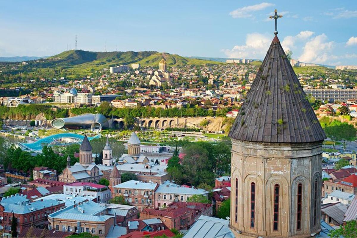 a church tower with a cross on top of a city