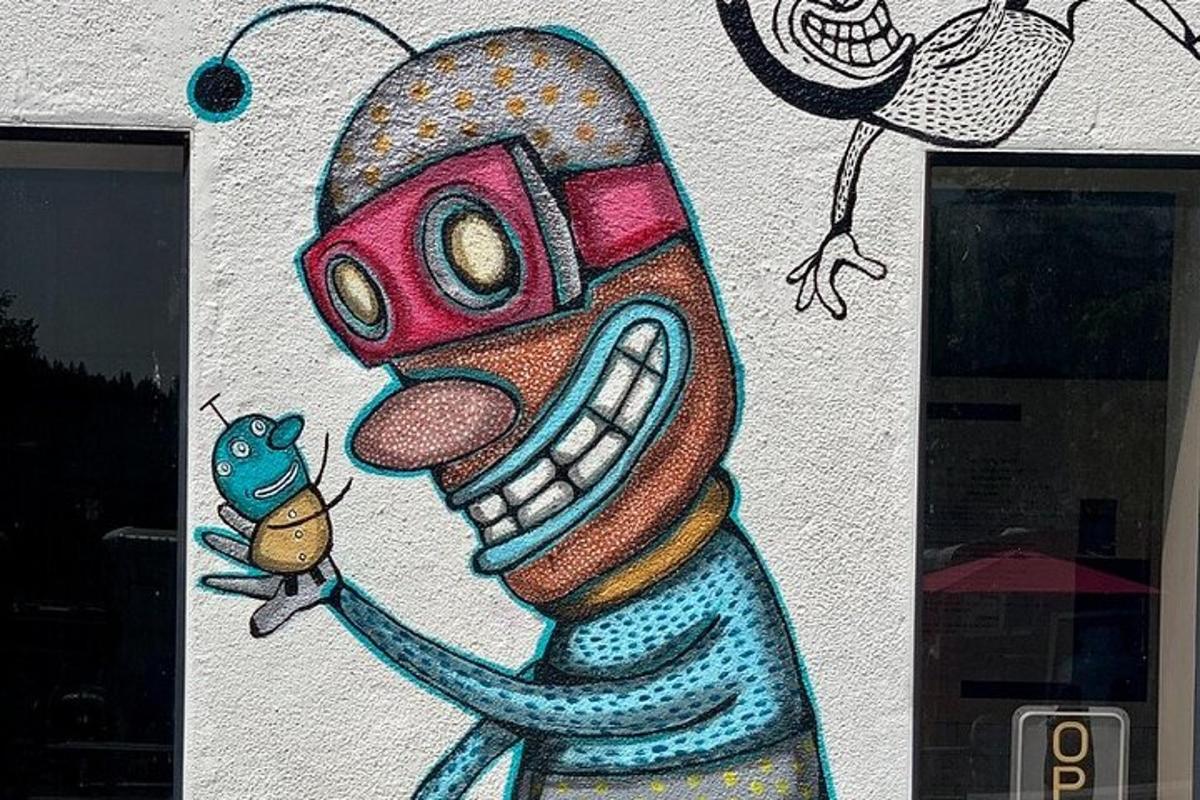 a wall with a painting of a monster and a fish
