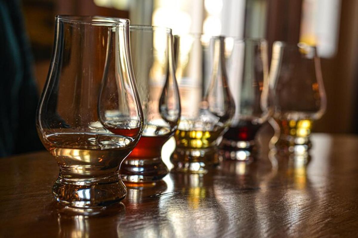 a group of wine glasses sitting on a wooden table