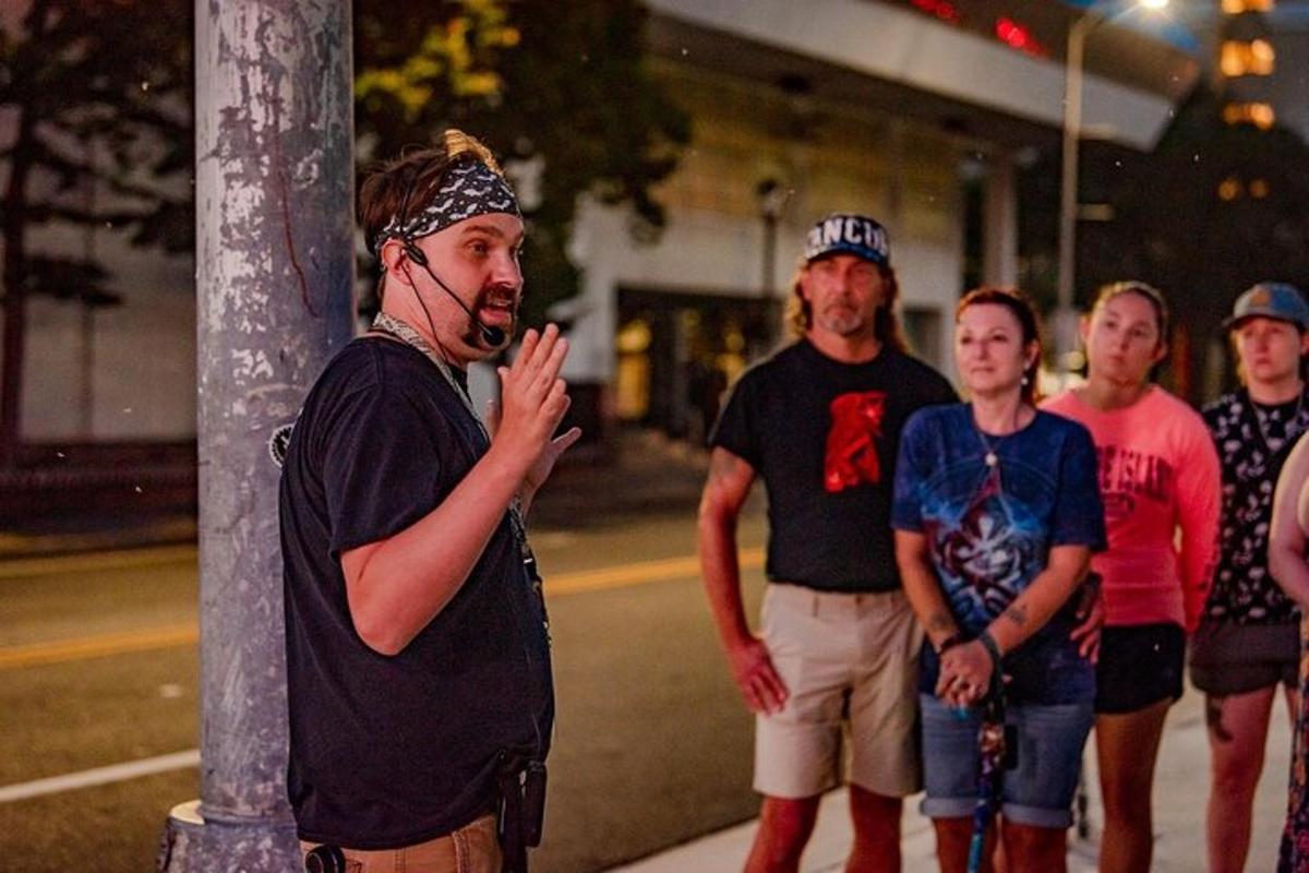 a group of people standing around a pole