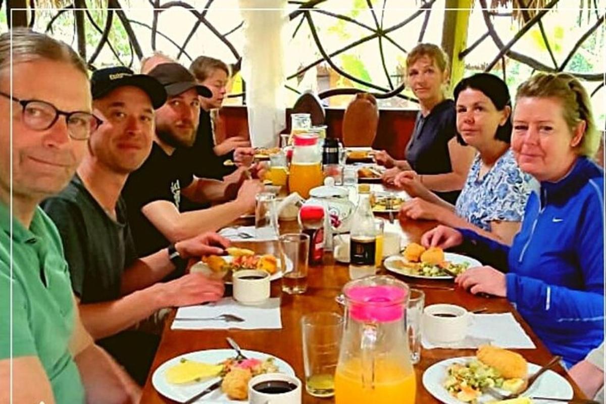a group of people sitting at a table eating food