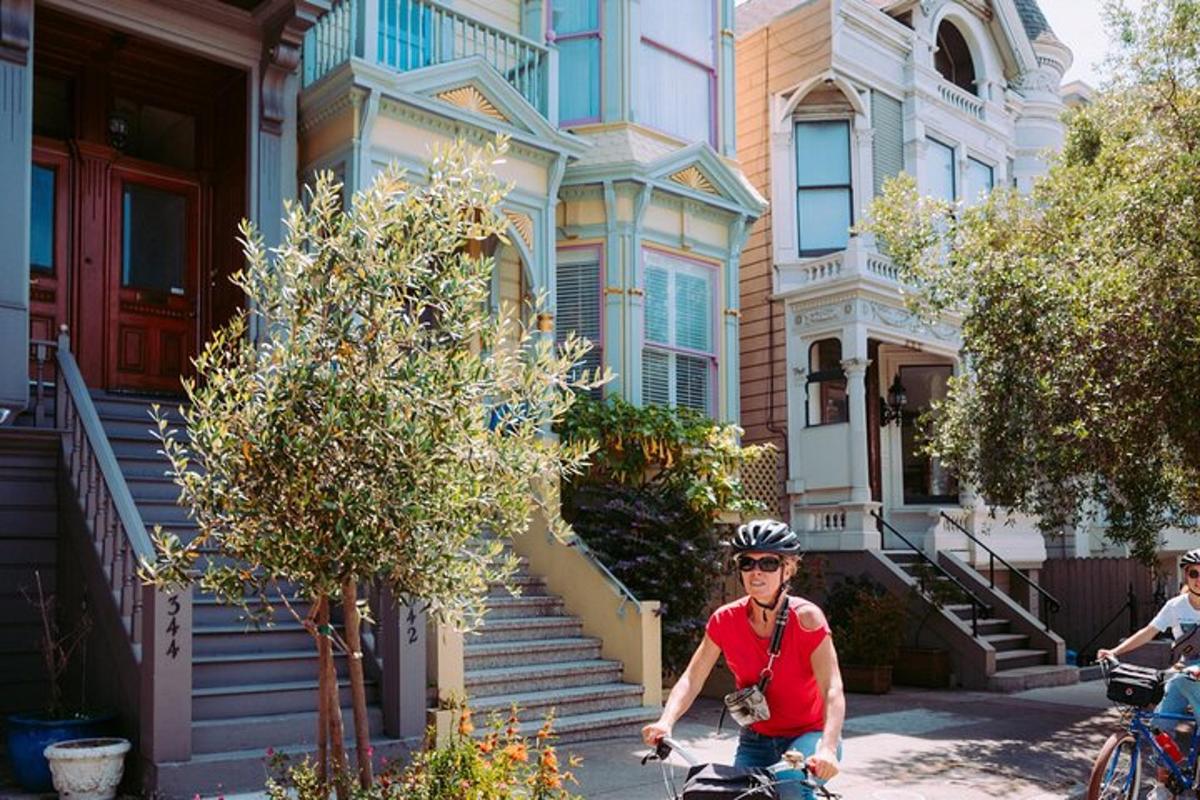 a man riding a bike in front of a house