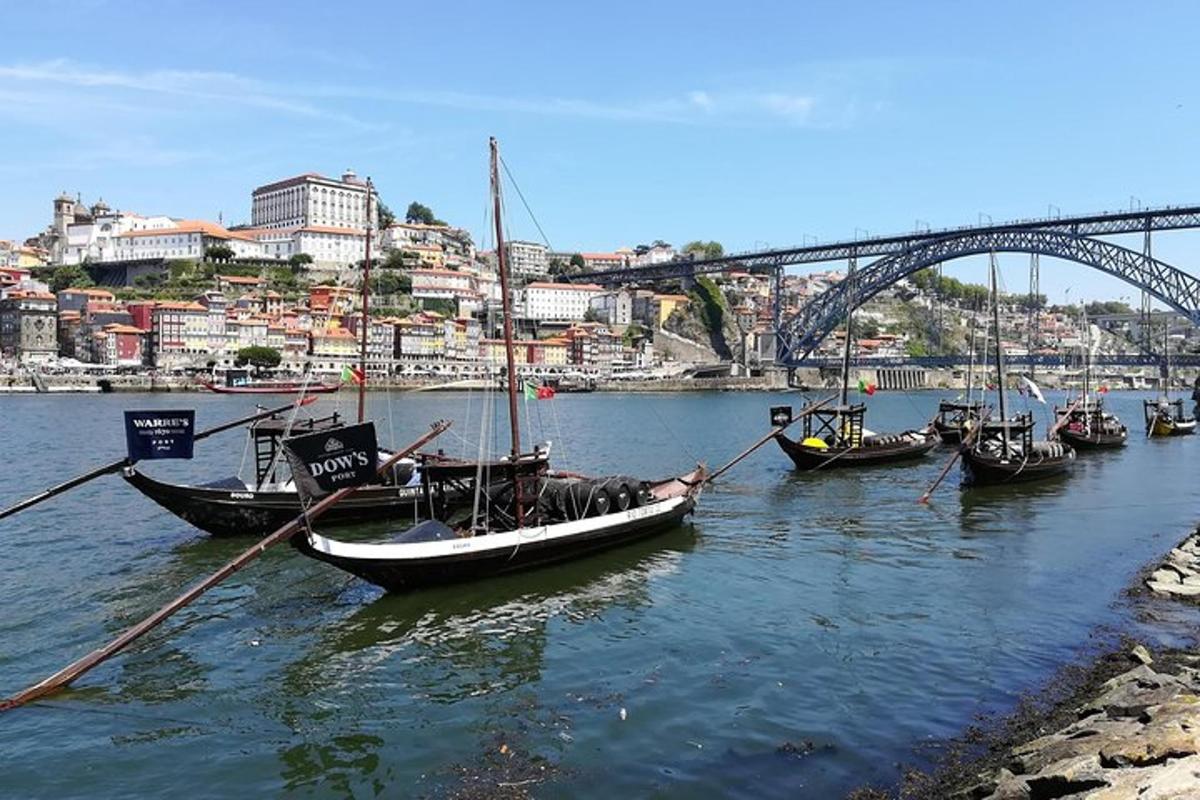 a group of boats in the water near a bridge