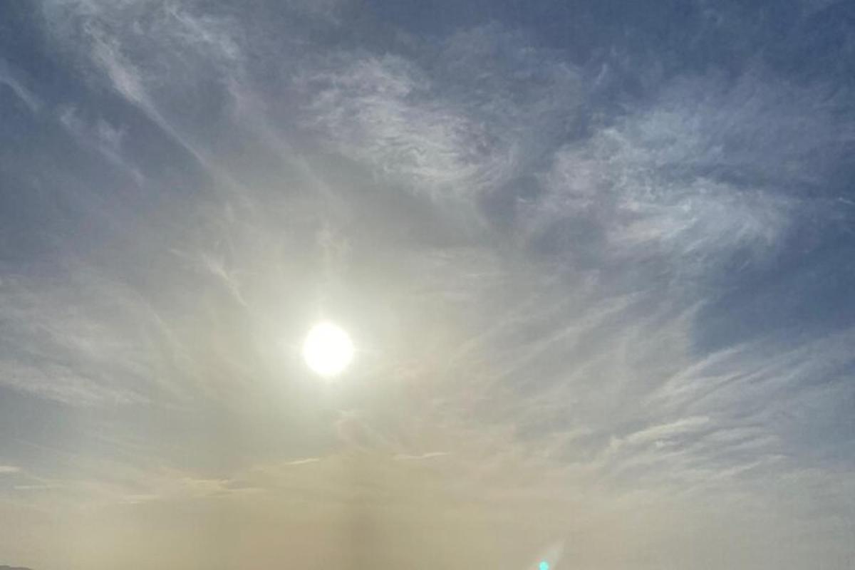 a sun in the sky with a cloudy sky