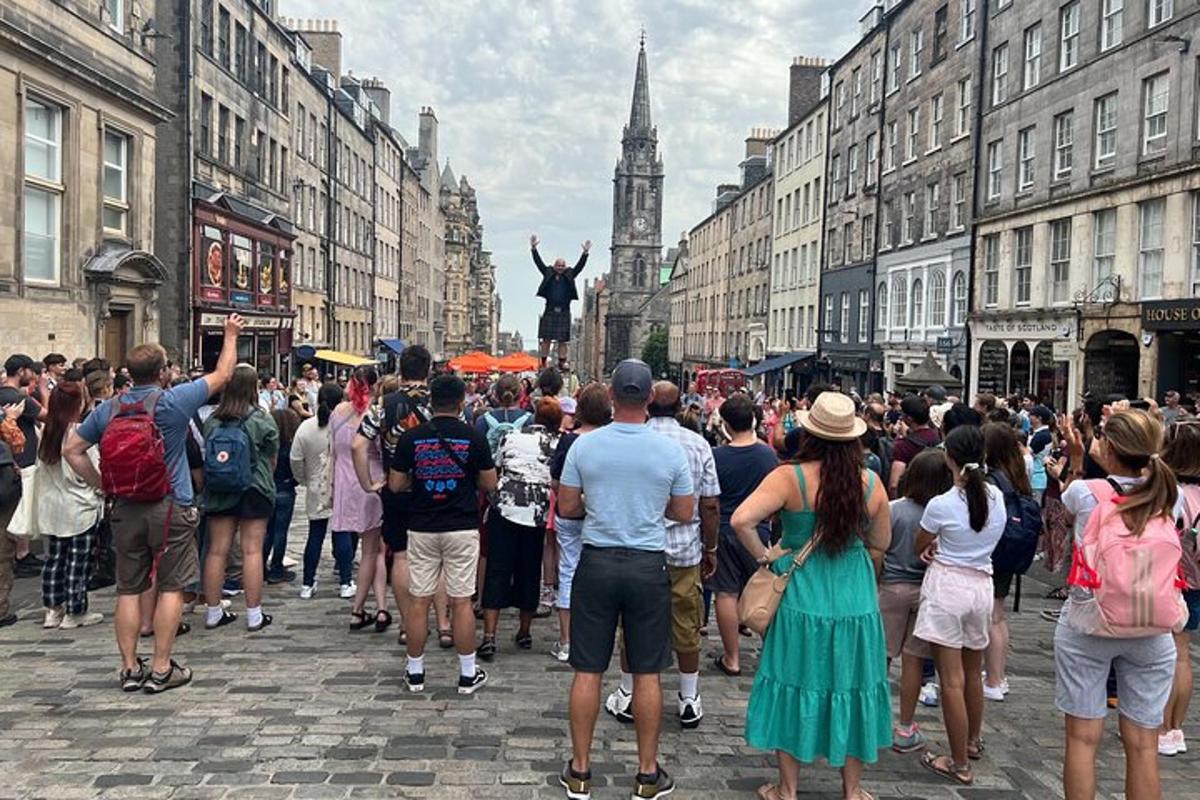 a crowd of people on a city street with a statue