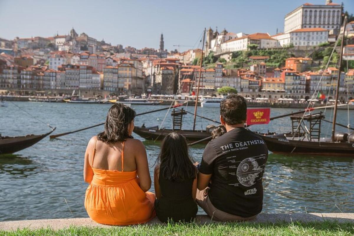 a group of three people sitting next to a body of water