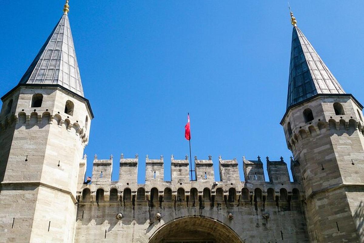a building with two towers with a flag on it