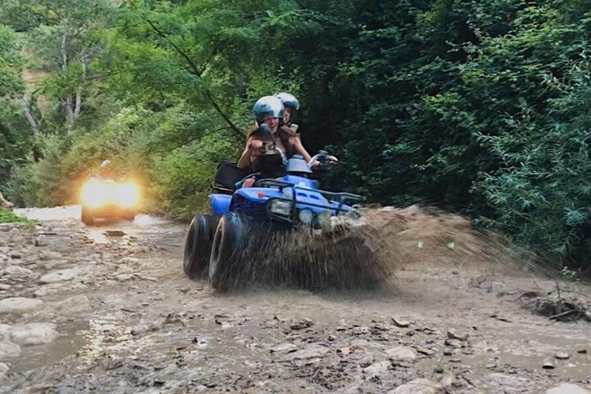 un uomo che guida un quad su una strada sterrata