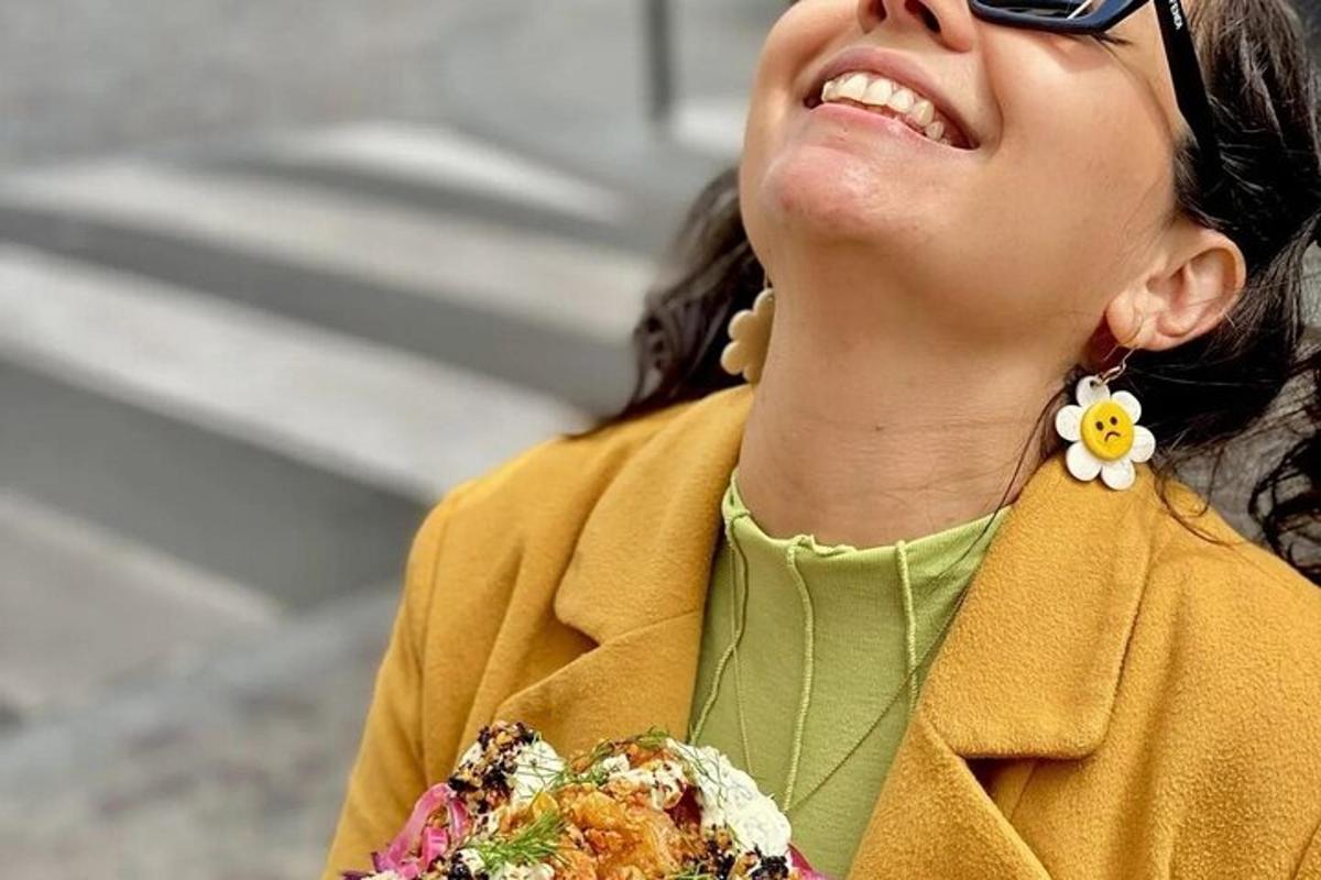 a woman wearing sunglasses is smiling and wearing a necklace