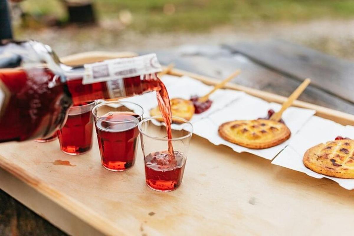a drink being poured into two glasses on a table