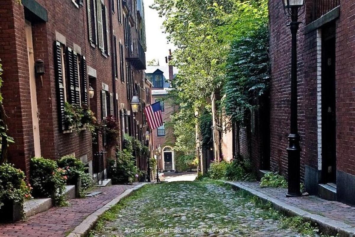 an empty street in an alley between brick buildings