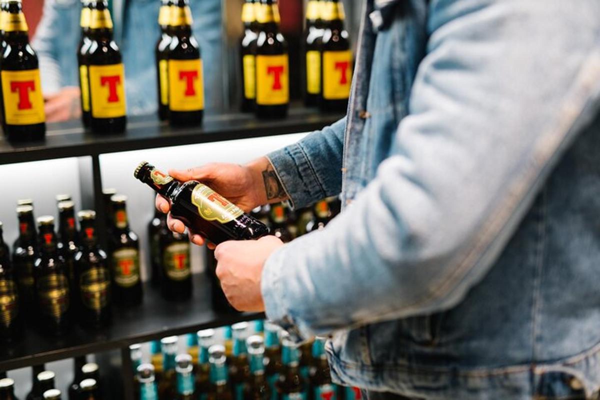 a man is holding a bottle of wine
