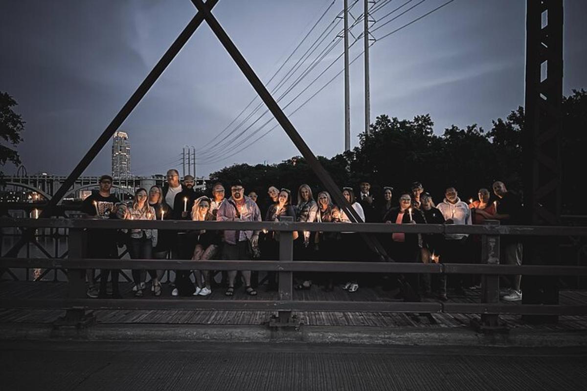 a group of people standing on a bridge