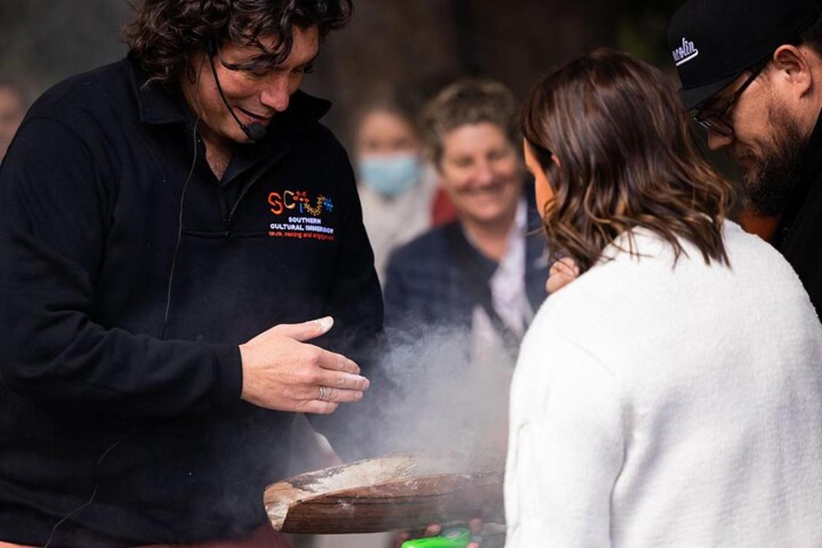 a man cooking food on a grill with a woman
