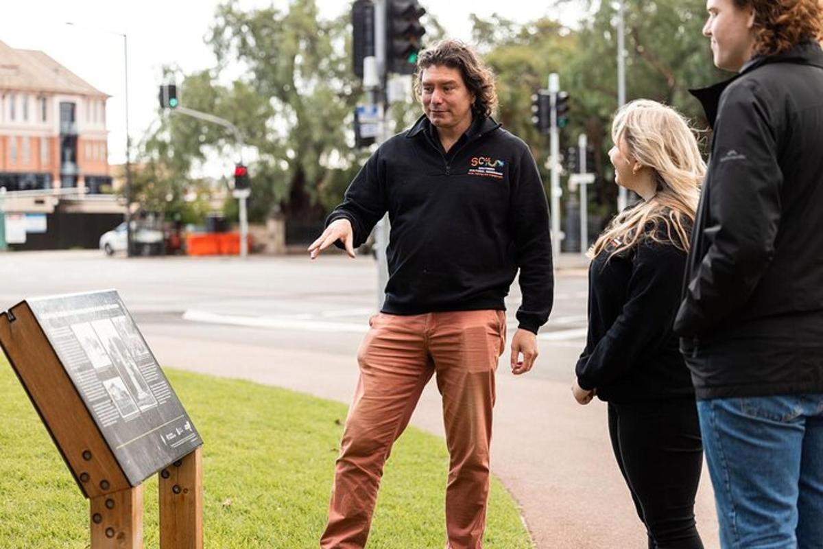 a man and two women standing on a sidewalk