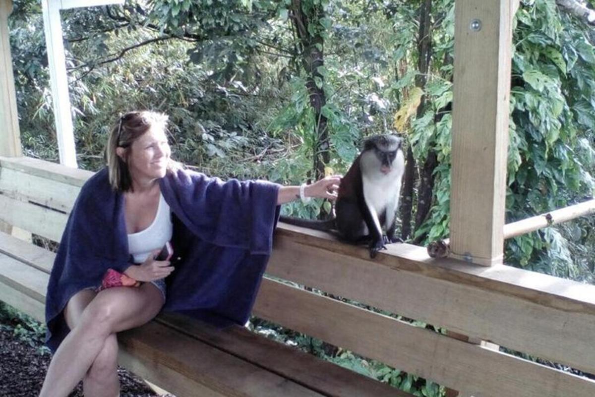 a woman sitting on a porch with a cat