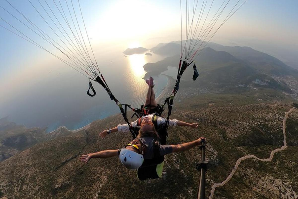 a person hanging from a parachute over a mountain