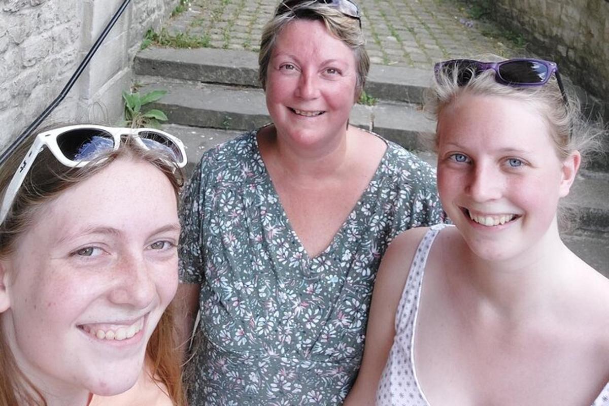 three women posing for a picture on some stairs