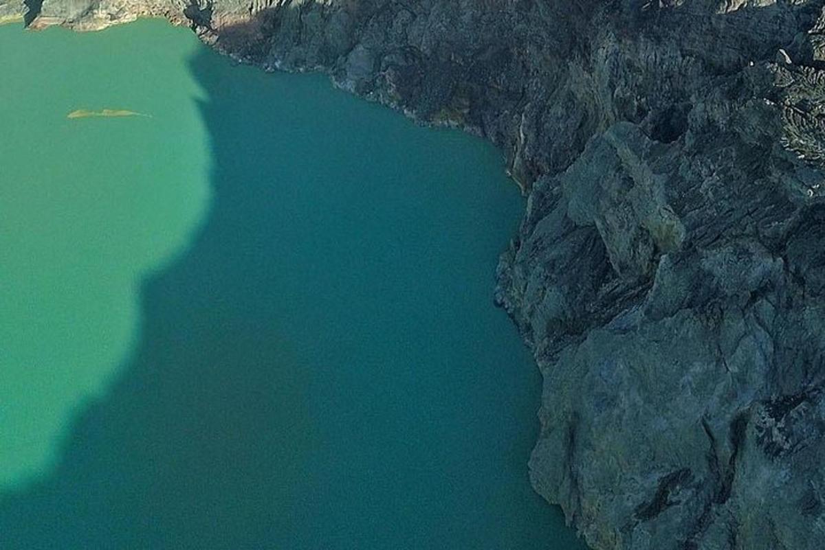 an aerial view of a body of water next to a cliff