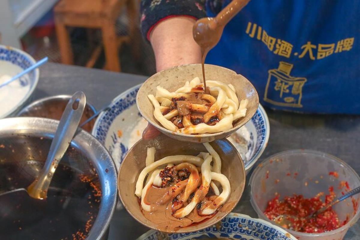 a person holding two bowls of food on a table