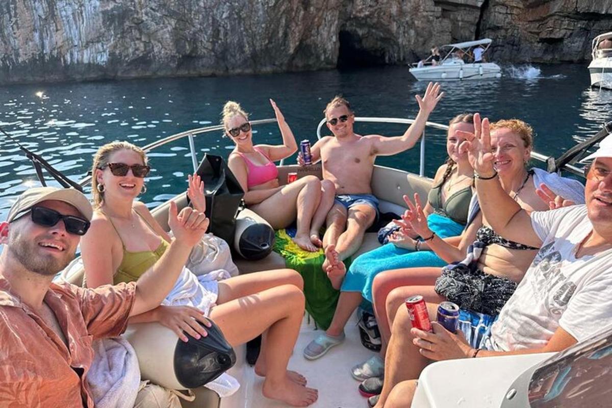 a group of people sitting on a boat in the water