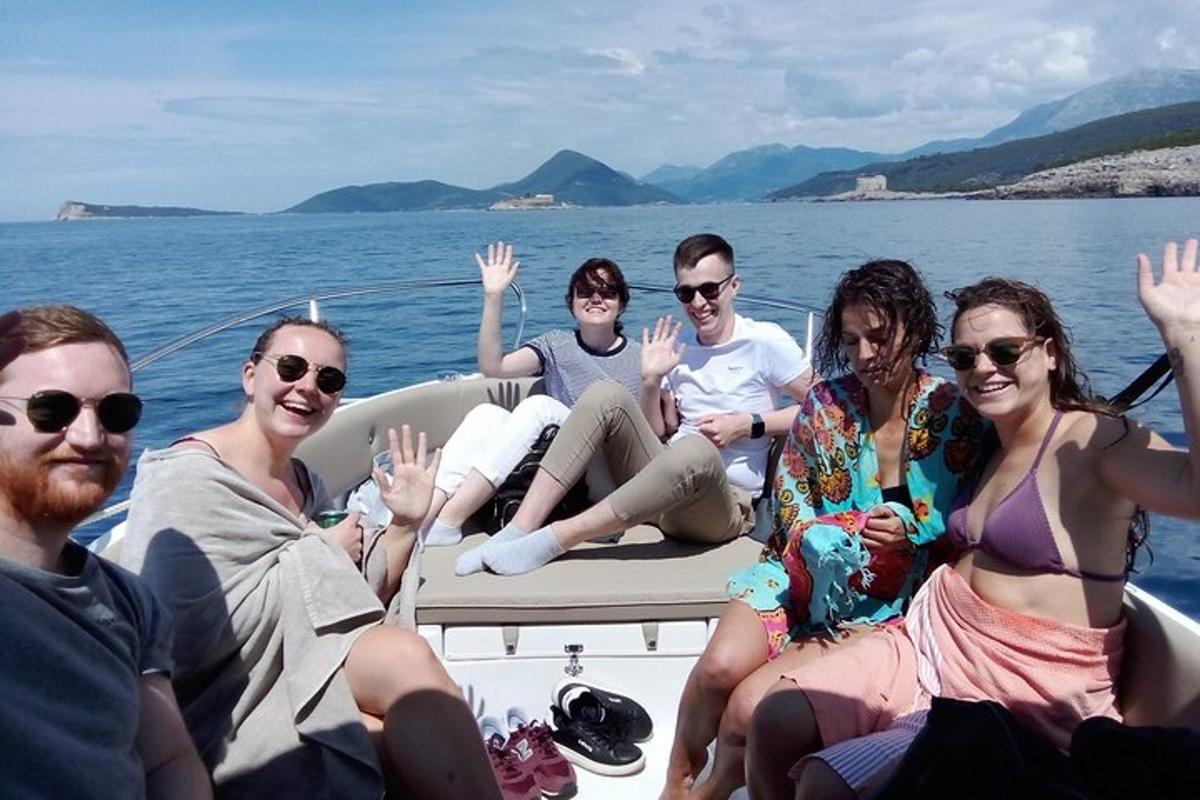a group of people sitting on a boat in the water