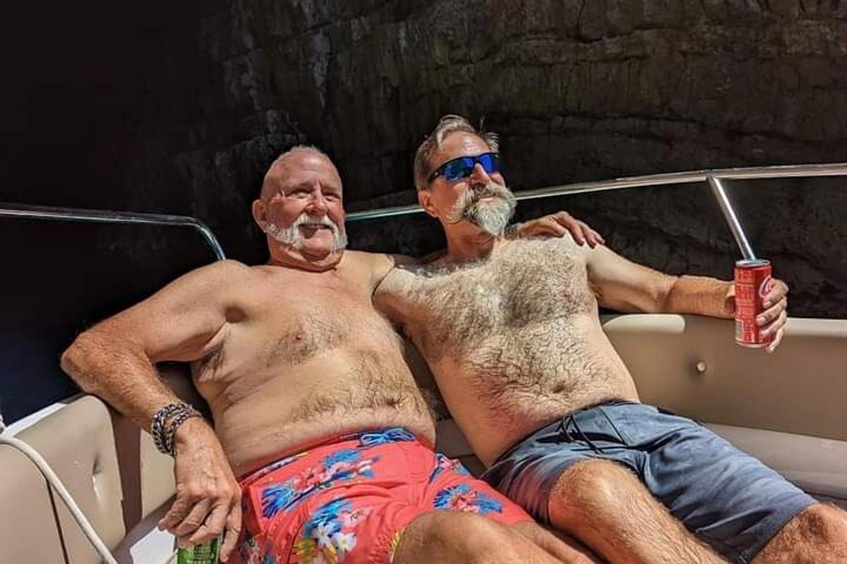 two men laying on a boat in a boat