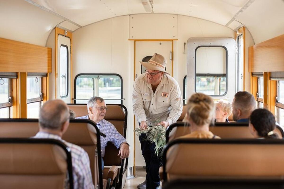 a man in a hat is standing in a train