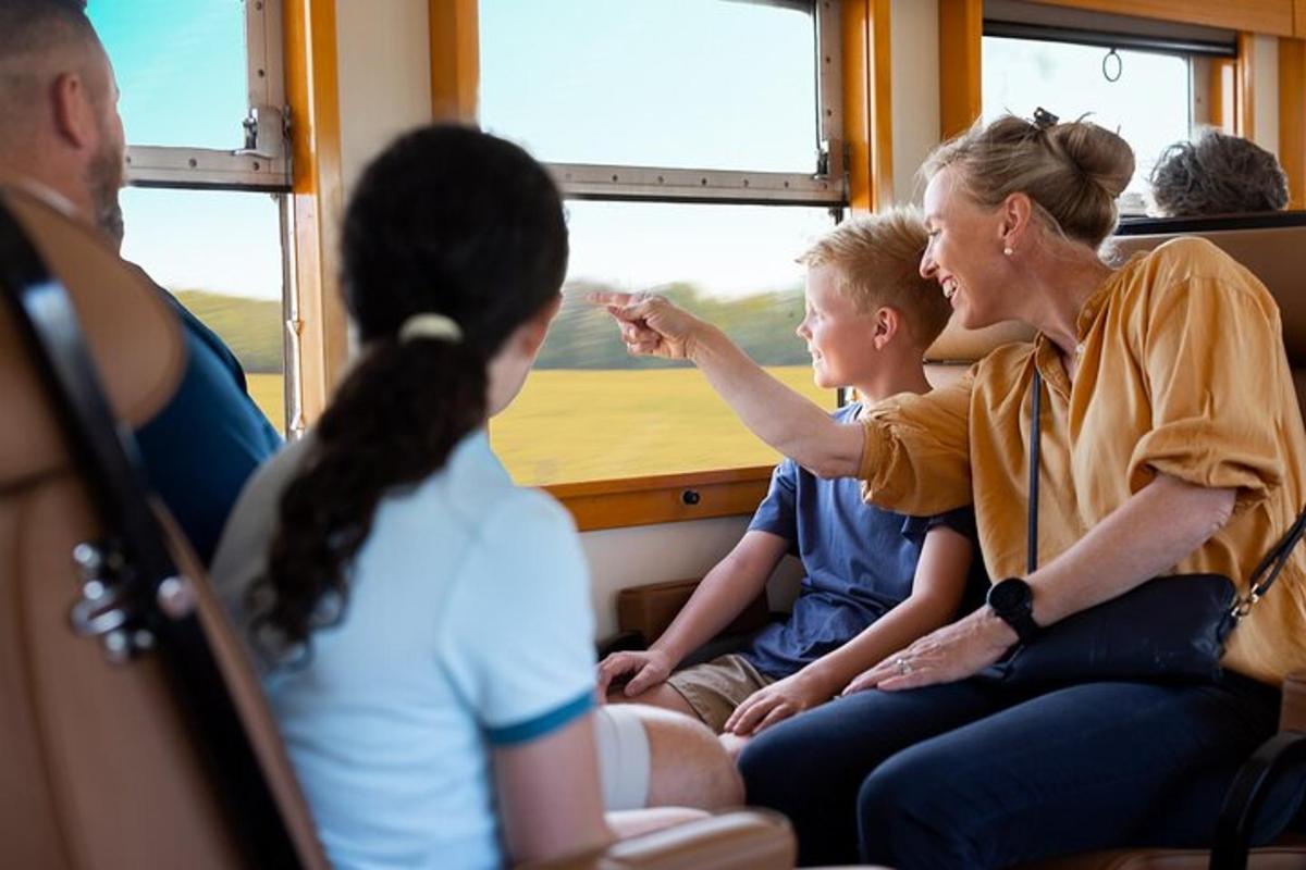 a woman and children sitting in a train looking out the window