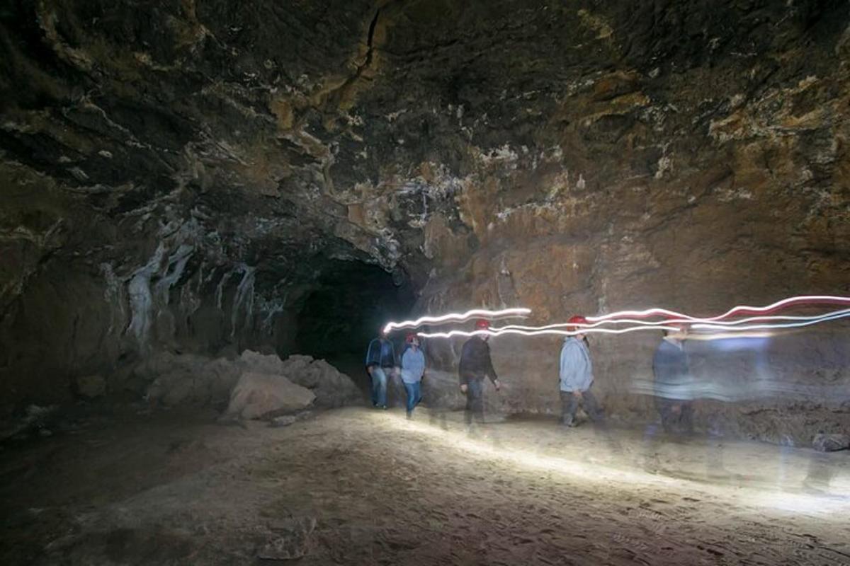 a group of people standing in a cave at night