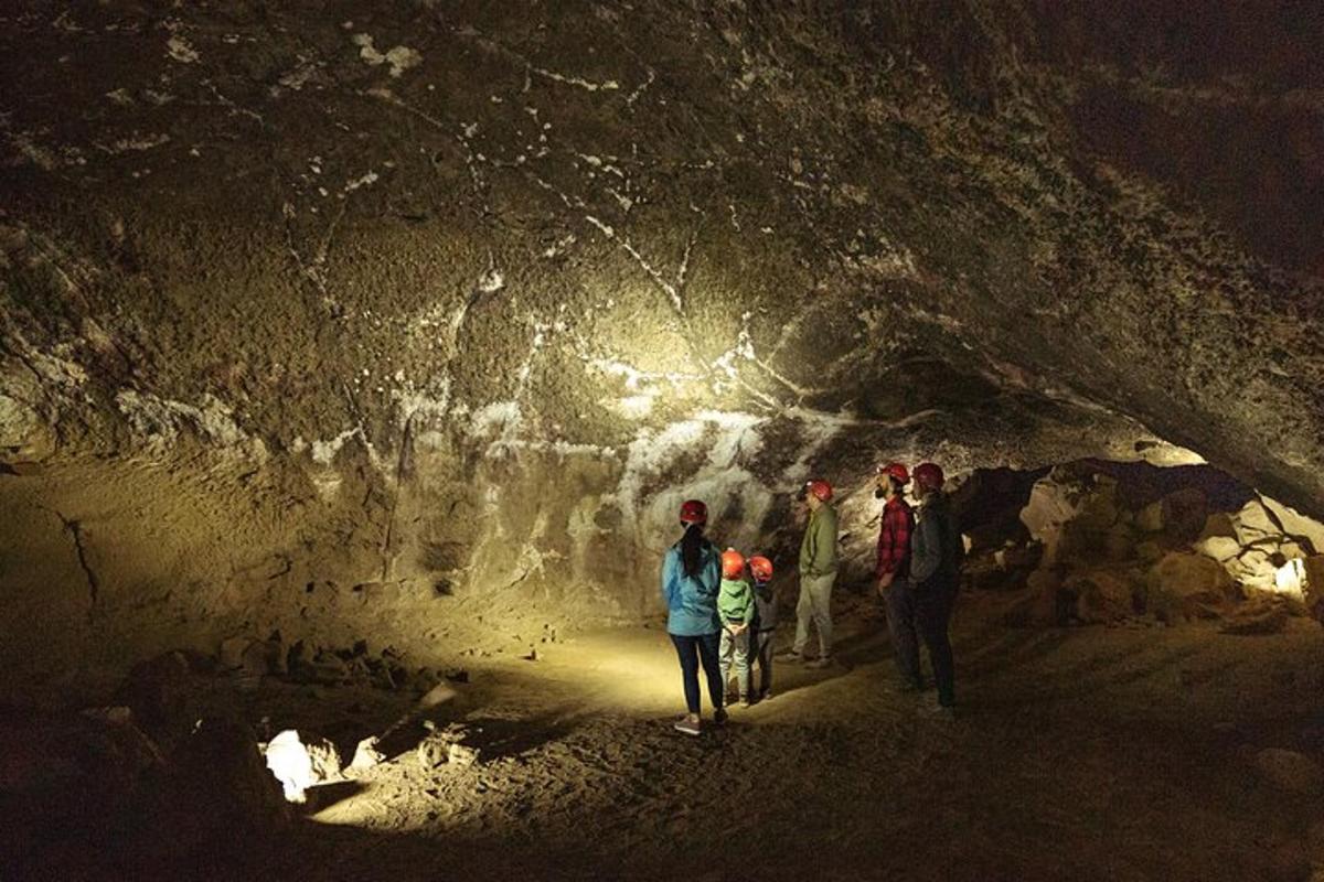 a group of people walking through a cave