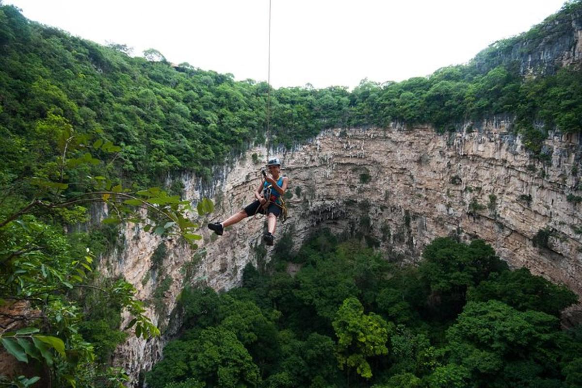 a man is jumping off of a cliff