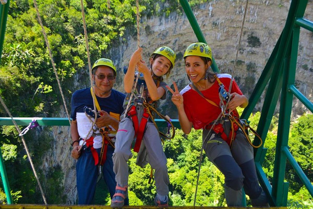 three people on a zip line on theipline