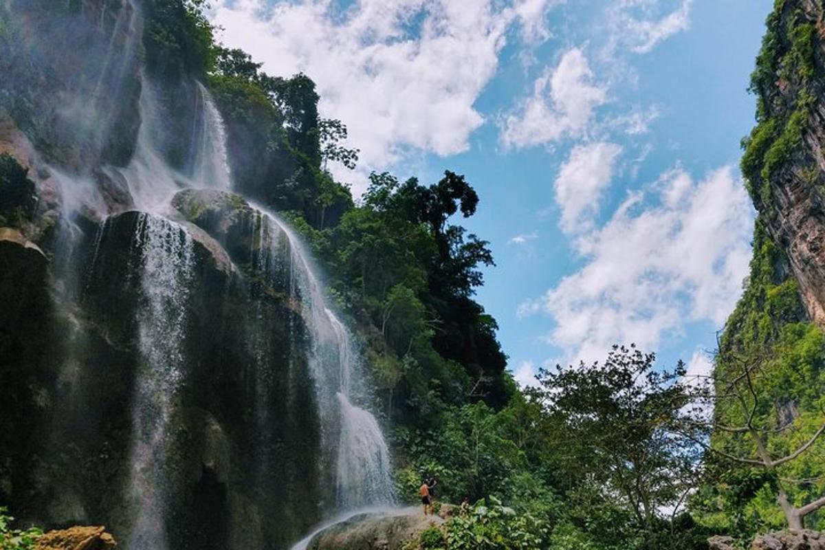 a person standing in front of a waterfall