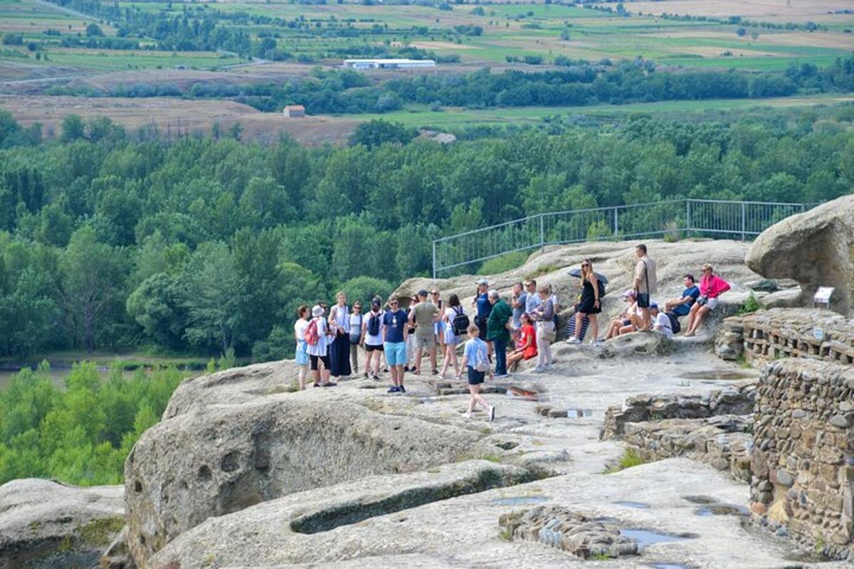 a group of people standing on top of rocks