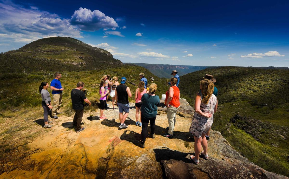 a group of people standing on top of a mountain